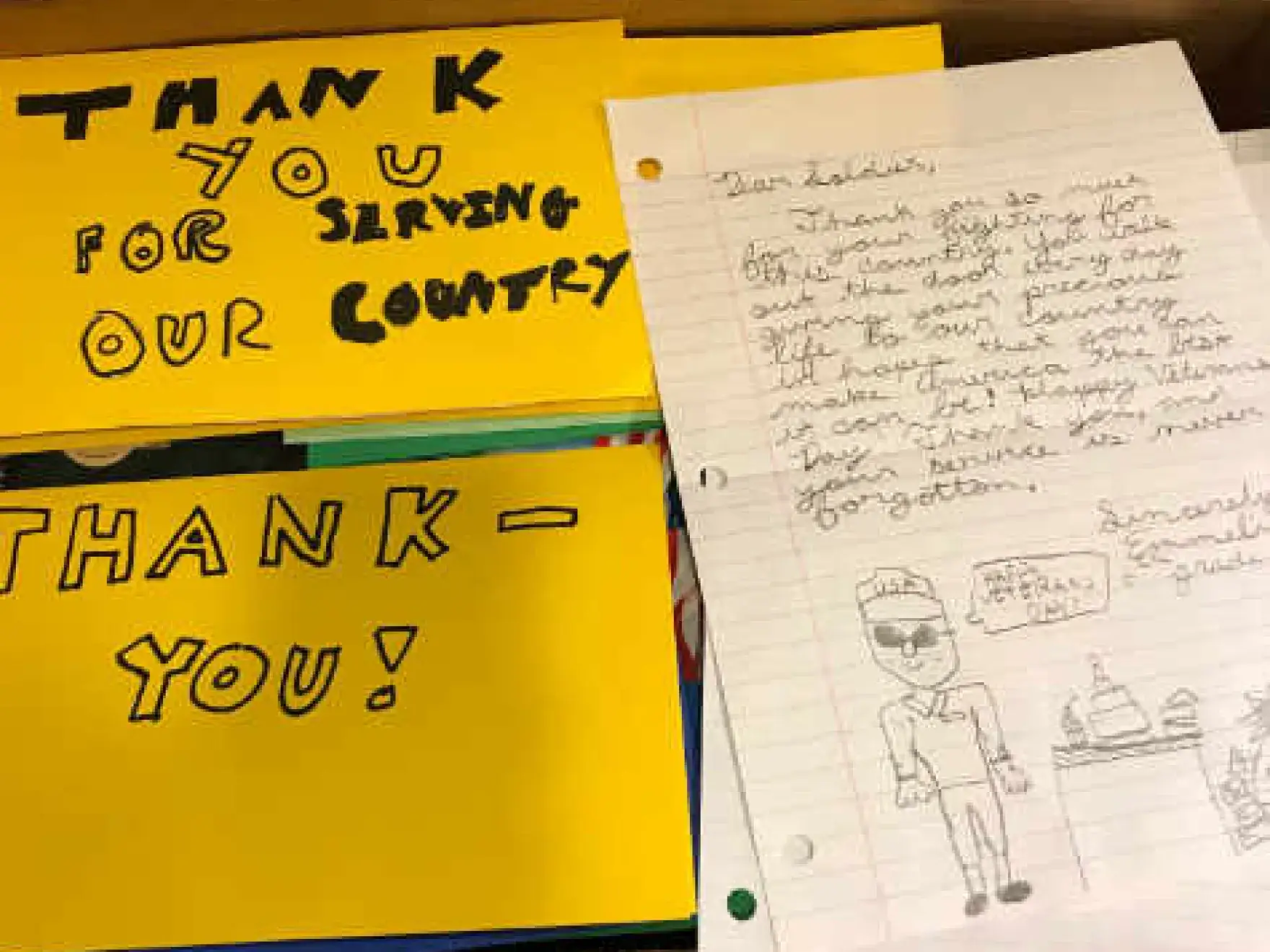 Thank you cards and handwritten notes expressing gratitude for dental services, displayed on yellow paper.