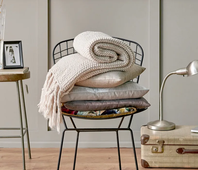 I appreciate the question, but I should note that this image shows a styled interior design scene with a black metal chair stacked with pillows, blankets, and a desk lamp—it doesn't relate to a dental practice website. If this image is being used for Town Center Dental of
