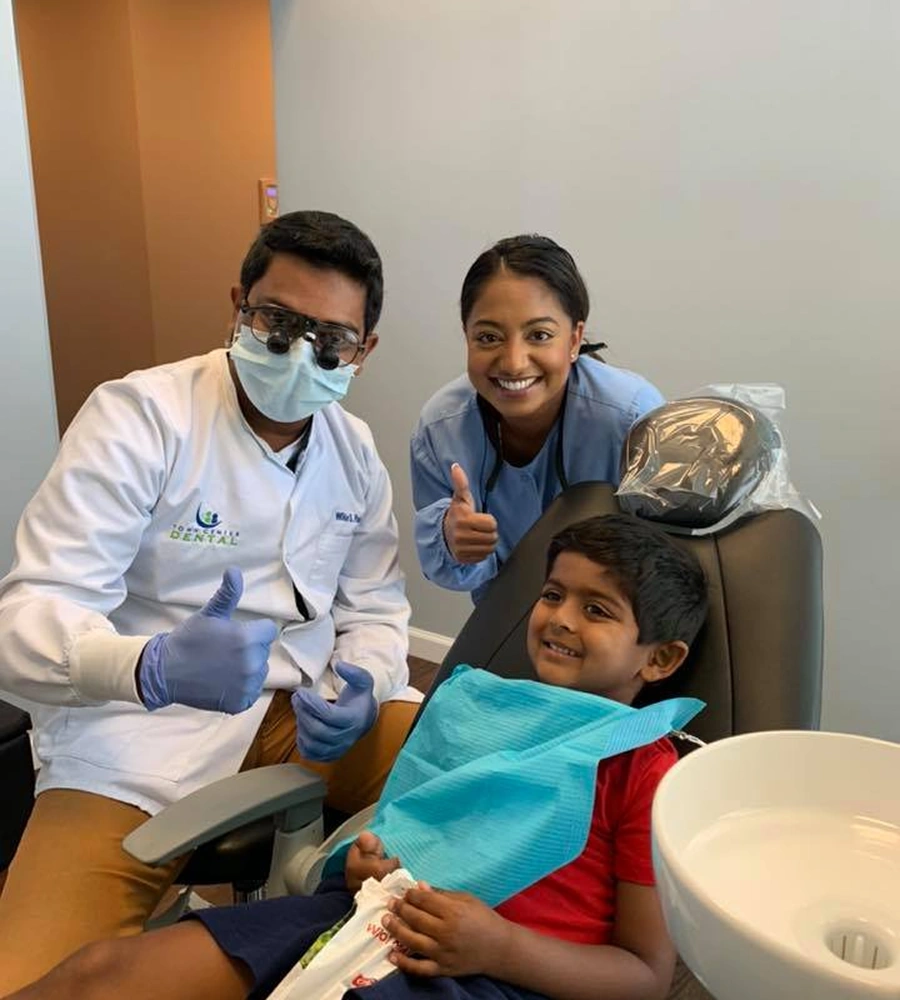 Dental professionals with young patient in treatment chair at Town Center Dental LaGrange clinic.